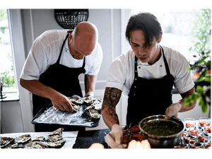 Chefs preparing dishes with the Annoncer Kitchen Management System supporting kitchen coordination