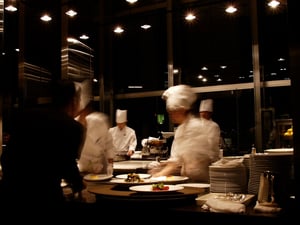 Chefs preparing dishes during peak restaurant service