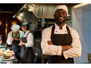 Confident chef working in a calm and organized kitchen with Annoncer