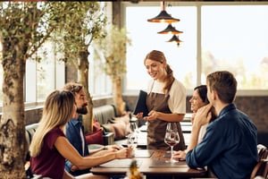Server assisting guests in a fine dining restaurant
